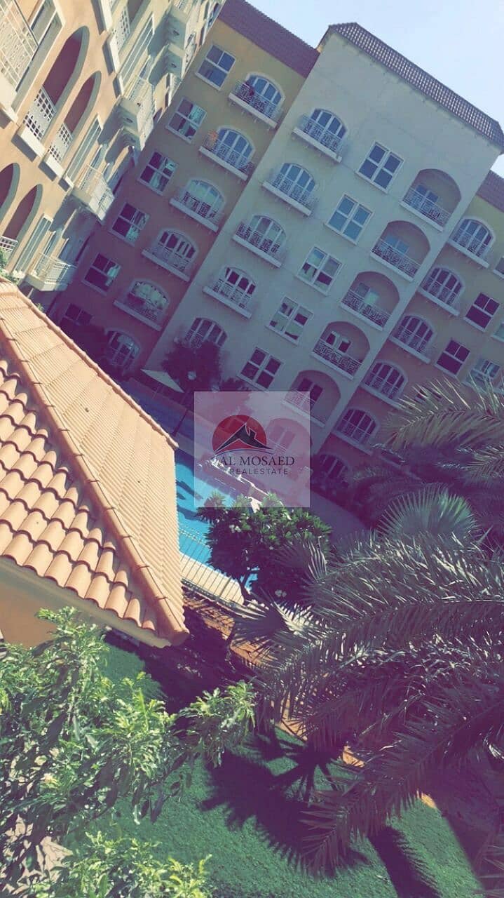 Palm trees and low-rise blocks in the Ritaj community, Dubai Investments Park